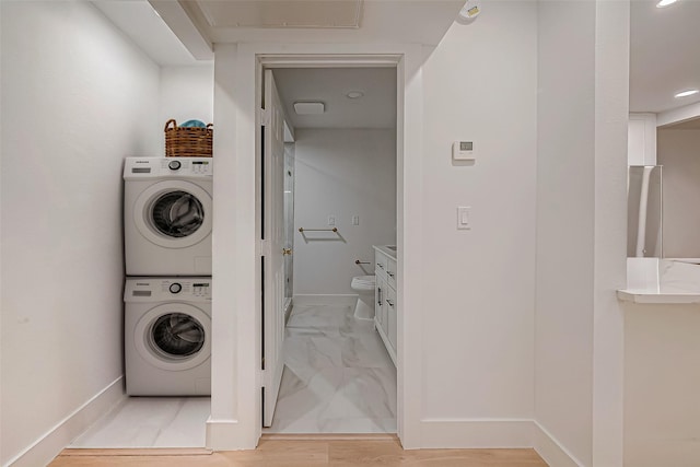 washroom with stacked washing maching and dryer