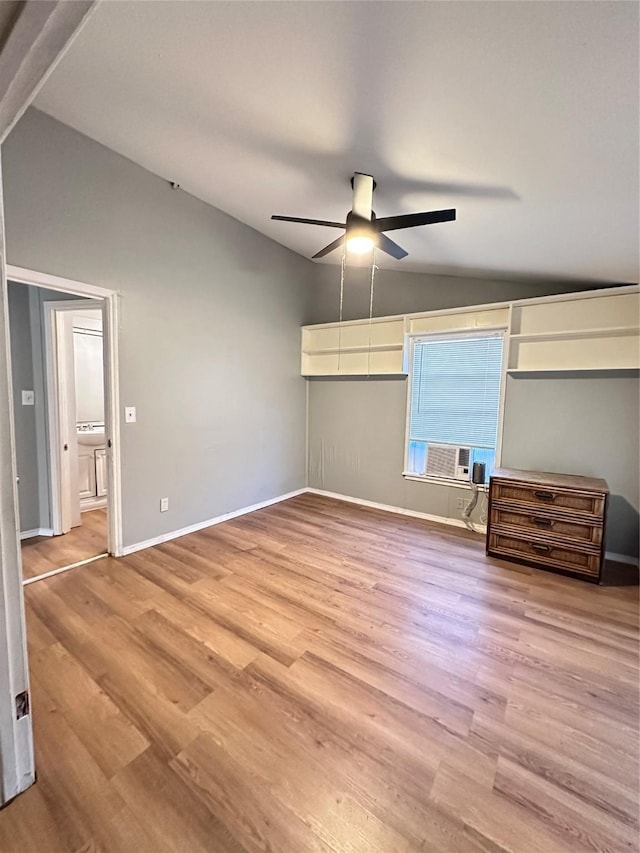 unfurnished bedroom with ceiling fan, cooling unit, light hardwood / wood-style flooring, and vaulted ceiling