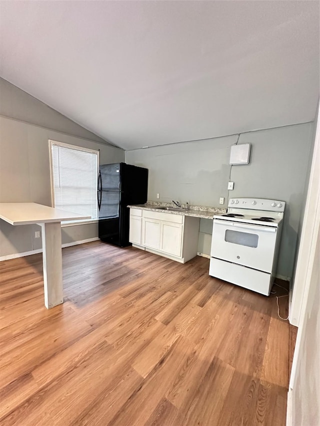 kitchen featuring white electric range, black refrigerator, vaulted ceiling, a breakfast bar, and white cabinets