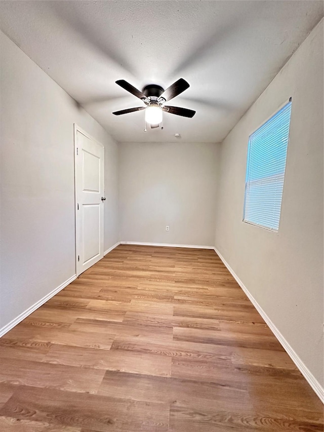 unfurnished room with ceiling fan and light hardwood / wood-style floors