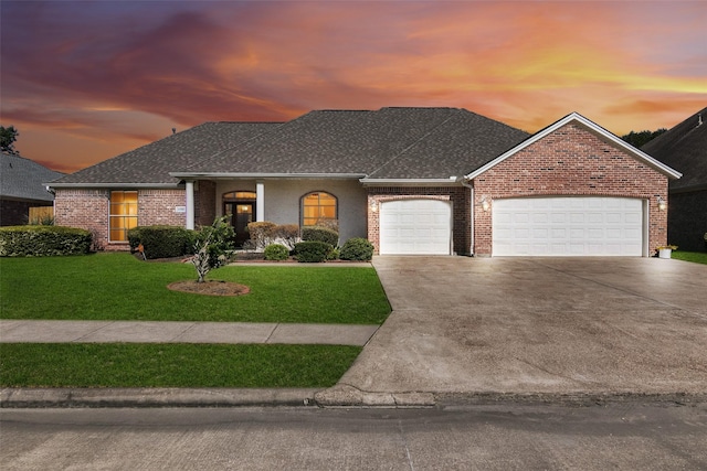 view of front of house featuring a lawn and a garage