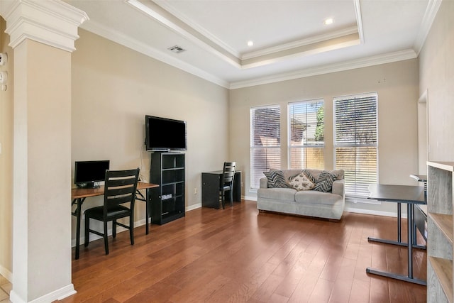 home office featuring a tray ceiling, dark hardwood / wood-style floors, and ornamental molding