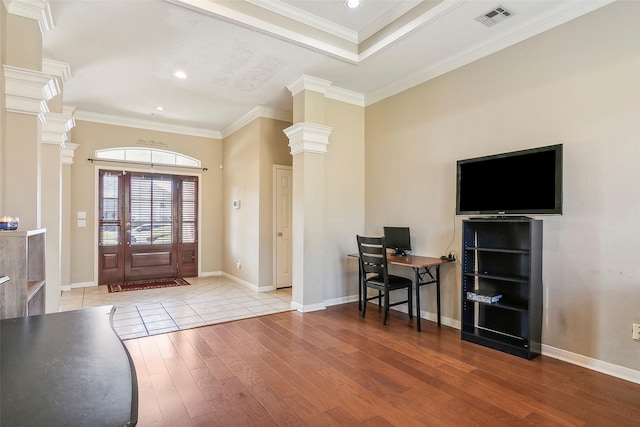 entryway with crown molding and light wood-type flooring