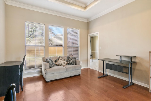 living area with a tray ceiling, crown molding, and hardwood / wood-style flooring