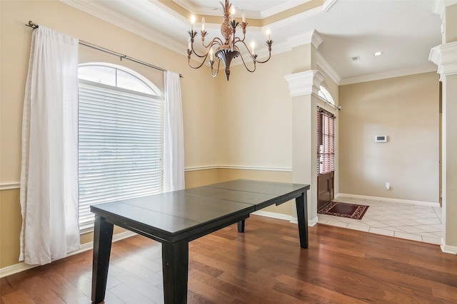 unfurnished dining area featuring hardwood / wood-style floors, crown molding, and a wealth of natural light