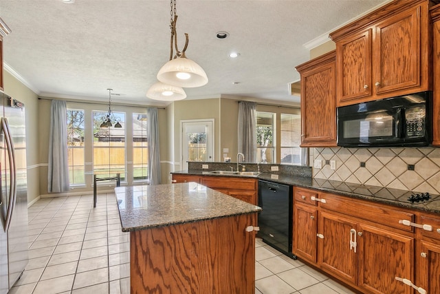 kitchen with backsplash, black appliances, sink, light tile patterned floors, and decorative light fixtures