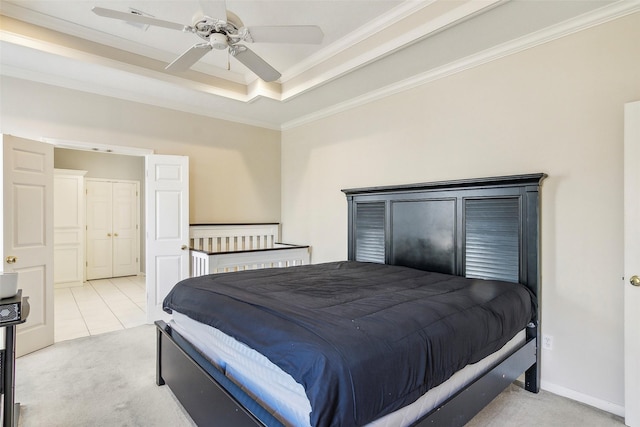 carpeted bedroom featuring a tray ceiling, ceiling fan, and ornamental molding