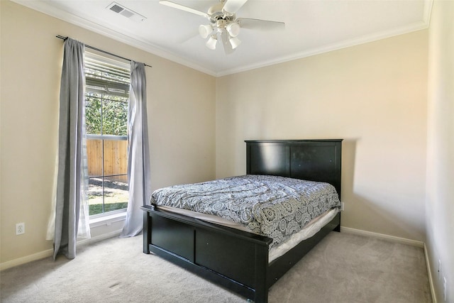 bedroom featuring multiple windows, carpet floors, ceiling fan, and ornamental molding