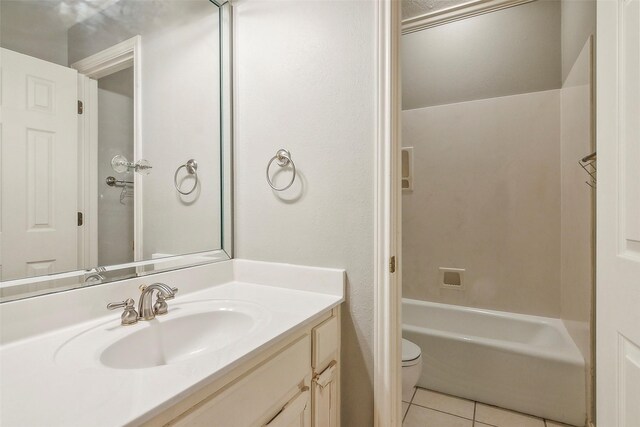 full bathroom featuring tile patterned flooring, vanity, toilet, and washtub / shower combination