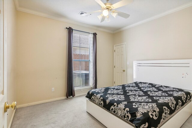 carpeted bedroom featuring ceiling fan and crown molding