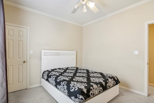 carpeted bedroom featuring ceiling fan and crown molding