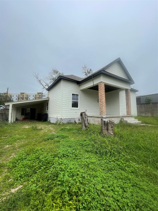 view of side of property featuring a yard