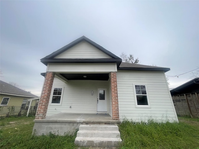 back of property with covered porch