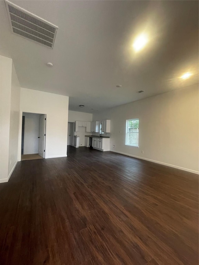 unfurnished living room featuring dark hardwood / wood-style flooring