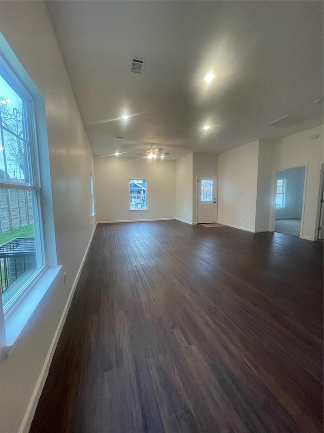 spare room featuring ceiling fan and dark wood-type flooring