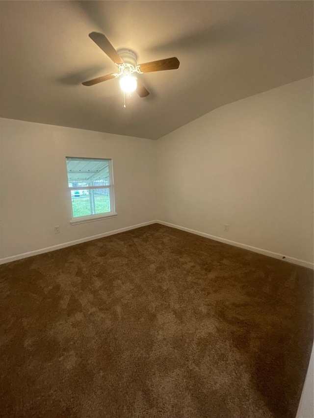 carpeted spare room featuring ceiling fan and lofted ceiling