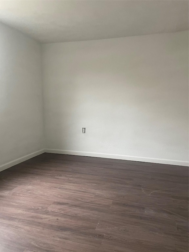 empty room featuring dark hardwood / wood-style flooring