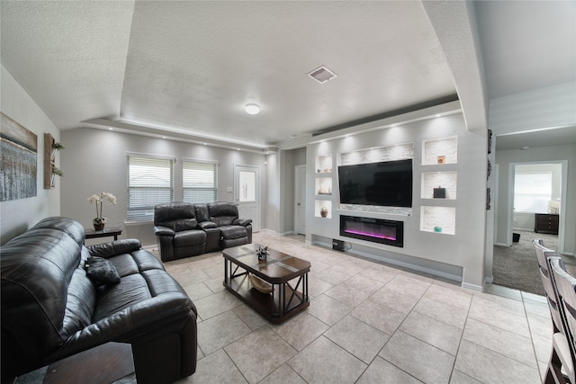 living room featuring lofted ceiling, light tile patterned floors, and a textured ceiling