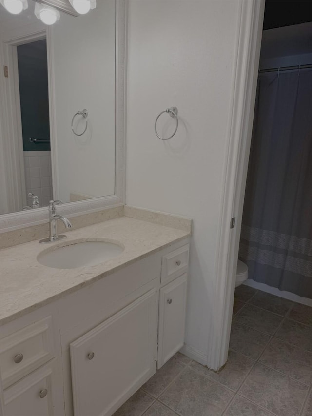 bathroom with tile patterned floors, vanity, and toilet