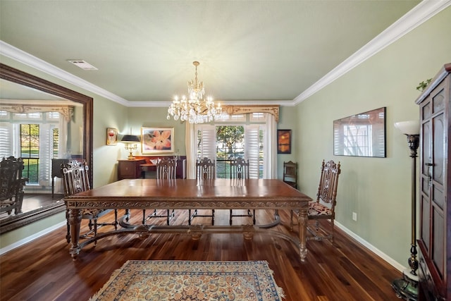 dining room featuring dark wood-type flooring, crown molding, and a notable chandelier