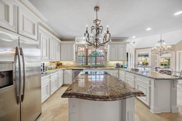 kitchen with a kitchen island, kitchen peninsula, stainless steel appliances, and hanging light fixtures