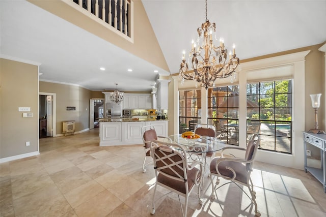 dining space with high vaulted ceiling, crown molding, a wealth of natural light, and decorative columns