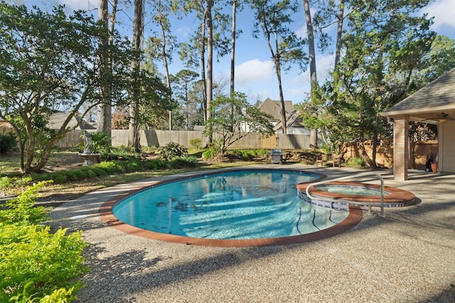 view of pool featuring a patio area and an in ground hot tub