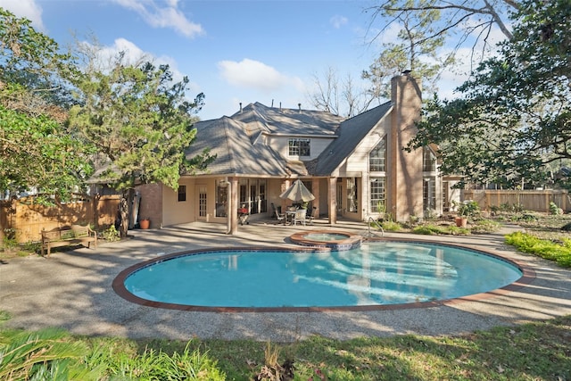 view of pool featuring a patio area and an in ground hot tub