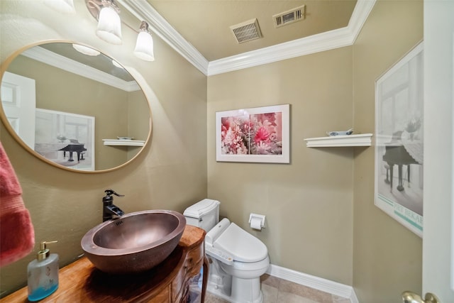 bathroom with crown molding, sink, tile patterned flooring, and toilet