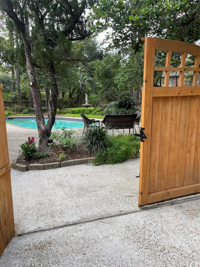 view of gate featuring a patio area