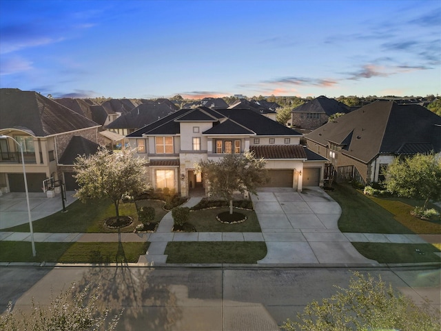 view of front of house featuring a yard and a garage