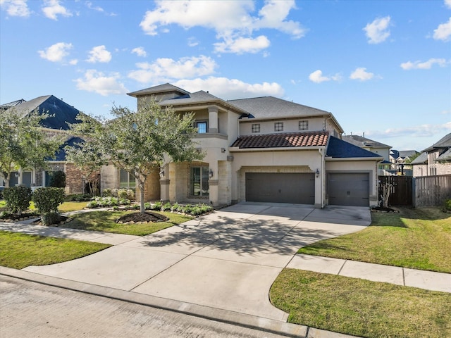 view of front of property featuring a front yard and a garage