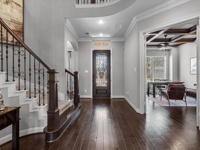 entrance foyer with beamed ceiling, dark wood-type flooring, crown molding, and coffered ceiling