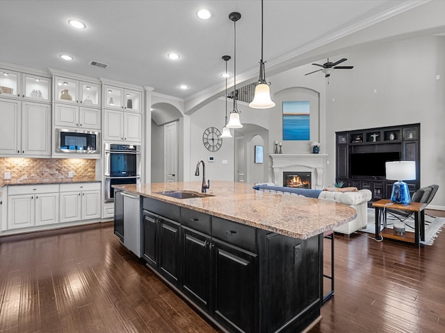 kitchen featuring white cabinetry, sink, ceiling fan, stainless steel appliances, and tasteful backsplash