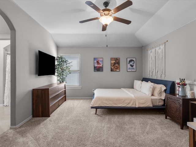 carpeted bedroom featuring ceiling fan and vaulted ceiling