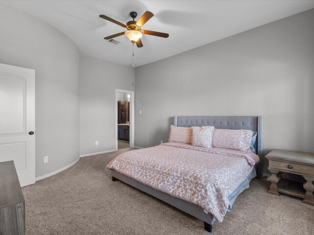 carpeted bedroom with ensuite bathroom and ceiling fan