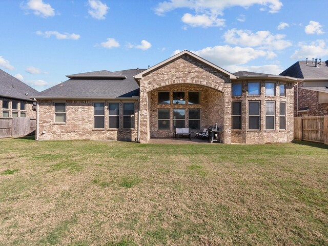 rear view of property with a yard