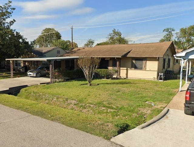 single story home featuring a front lawn and a carport