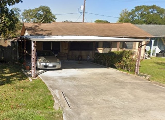 view of front of property with a front lawn and a carport