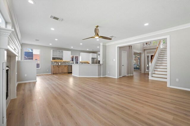 unfurnished living room with ceiling fan, light hardwood / wood-style floors, and ornamental molding