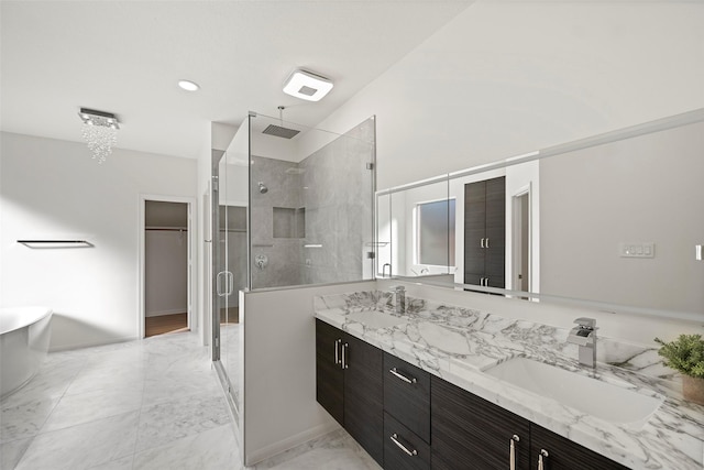 bathroom with vanity, a chandelier, and walk in shower