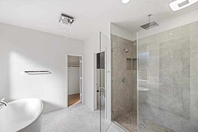 bathroom with separate shower and tub and a chandelier