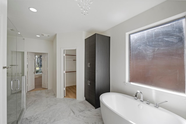 bathroom featuring shower with separate bathtub and plenty of natural light