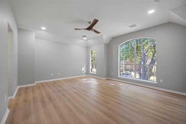 empty room featuring light hardwood / wood-style floors, ceiling fan, and lofted ceiling