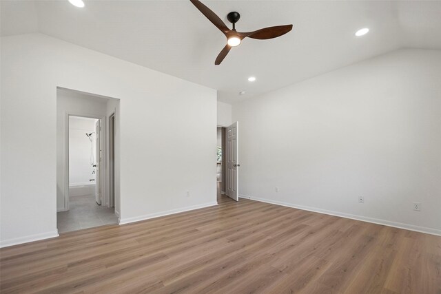 interior space with ceiling fan, lofted ceiling, and light hardwood / wood-style flooring