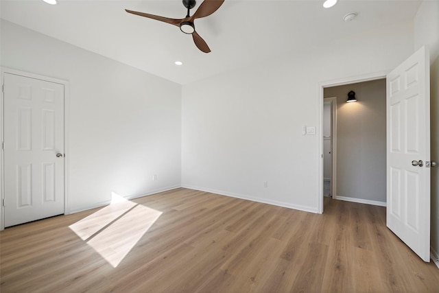 spare room with ceiling fan and light hardwood / wood-style flooring