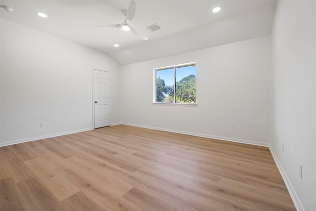 empty room featuring light wood-type flooring, vaulted ceiling, and ceiling fan