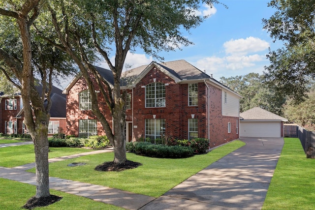 view of front of home with a garage, an outbuilding, and a front lawn