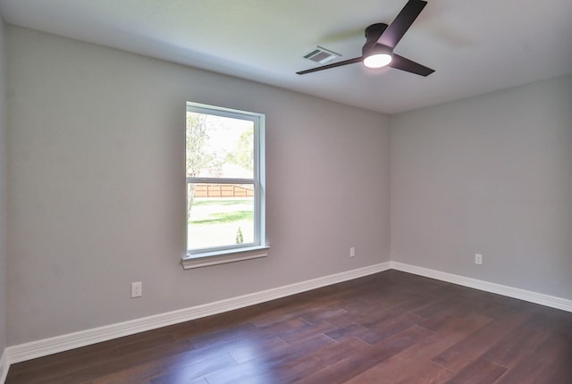 spare room featuring ceiling fan and dark wood-type flooring