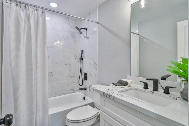 full bathroom featuring shower / bathtub combination with curtain, vanity, and toilet